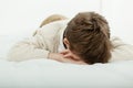 Young boy lying on his bed sleeping or crying Royalty Free Stock Photo