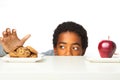 Little boy making decisions of eating healthy verses unhealthy. Royalty Free Stock Photo