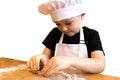 Young boy making gingerbread. Kid cutting cookies with molds, baking it for Christmas table. Isolated on white