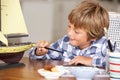 Young boy making model ship Royalty Free Stock Photo