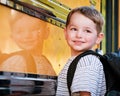 Young boy with nervous smile waits to board bus Royalty Free Stock Photo