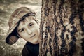 Young boy with newsboy cap playing detective