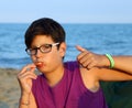 Young boy OK sign with thumb up eating pizza Royalty Free Stock Photo