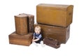 Young boy with old suitcases and boxes