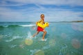 Happy boy run with inflatable duck in ocean at the beach Royalty Free Stock Photo