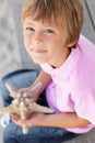 Young boy outdoors holding starfish Royalty Free Stock Photo