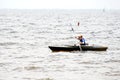 A young boy paddles along in the water in a kayak. Royalty Free Stock Photo