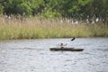 A young boy paddles along in the water in a kayak. Royalty Free Stock Photo