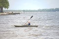 A young boy paddles along in the water in a kayak. Royalty Free Stock Photo