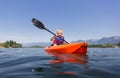 Young Boy paddling a kayak on a beautiful mountain lake Royalty Free Stock Photo