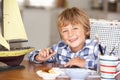 Young boy painting model ship