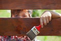Young boy painting the wooden fence Royalty Free Stock Photo