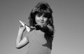 Young boy with paper plane against blue sky. Kid playing with paper airplane on sunny day. Royalty Free Stock Photo