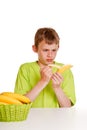 Young boy peeling a banana with distaste