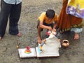 A young boy performs the traditional ritual of Lord Ganesh during Ganesh festival.