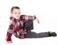 Young boy in plaid shirt laying on his side