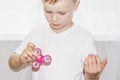 Young boy play with fidget spinner stress relieving toy. Popular toy Royalty Free Stock Photo