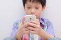 Young boy play game on smartphone Royalty Free Stock Photo