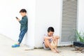 Young boy play smartphone compare with poor boy