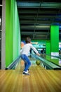 Young boy, playing bowling indoors Royalty Free Stock Photo