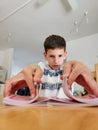 Young boy playing with cards in the kitchen. Selective focus. Royalty Free Stock Photo