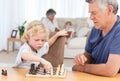 Young boy playing chess with his grandfather Royalty Free Stock Photo