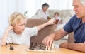 Young boy playing chess with his grandfather Royalty Free Stock Photo