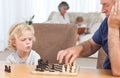 Young boy playing chess with his grandfather Royalty Free Stock Photo