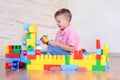 Young boy playing with colorful building blocks Royalty Free Stock Photo
