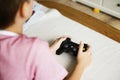 Young boy playing game using gaming console