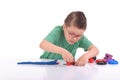 Young boy playing with modeling clay