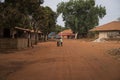 Young boy playing with an old tire in a dirt road in the town of Nhacra in Guinea Bissau, West Africa