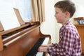 Young Boy Playing Piano At Home Royalty Free Stock Photo