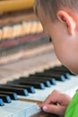 Young boy playing on the piano Royalty Free Stock Photo