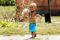 Young boy playing with rugby ball in Lavena village, Taveuni Isl