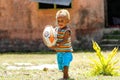 Young boy playing with rugby ball in Lavena village, Taveuni Isl
