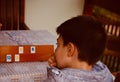 Young boy playing Rummy and looking for new strategies Royalty Free Stock Photo