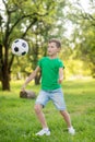 Young boy playing soccer ball in park Royalty Free Stock Photo