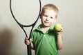 Young Boy Playing Tennis. Sport Children. Child with Tennis Racket and Ball