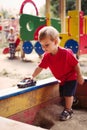 Young Boy Playing with Toy Car in Sandbox Royalty Free Stock Photo