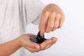 Young boy playing wiht black slime in his hand