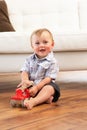 Young Boy Playing With Wooden Toy Car At Home Royalty Free Stock Photo