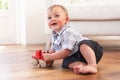 Young Boy Playing With Wooden Toy Car At Home Royalty Free Stock Photo