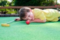 Young boy plays mini golf Royalty Free Stock Photo