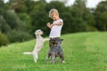 Young boy plays with two small dogs Royalty Free Stock Photo