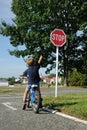 Young boy pointing to stop sign