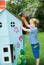 Young Boy Pretending To Fix Cardboard Playhouse Royalty Free Stock Photo