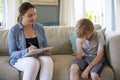 Young Boy With Problems Talking With Counselor At Home Royalty Free Stock Photo