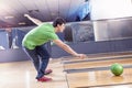 Young boy pulls the ball on the bowling alley Royalty Free Stock Photo