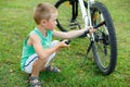 Young boy pumping the bicycle tube Royalty Free Stock Photo